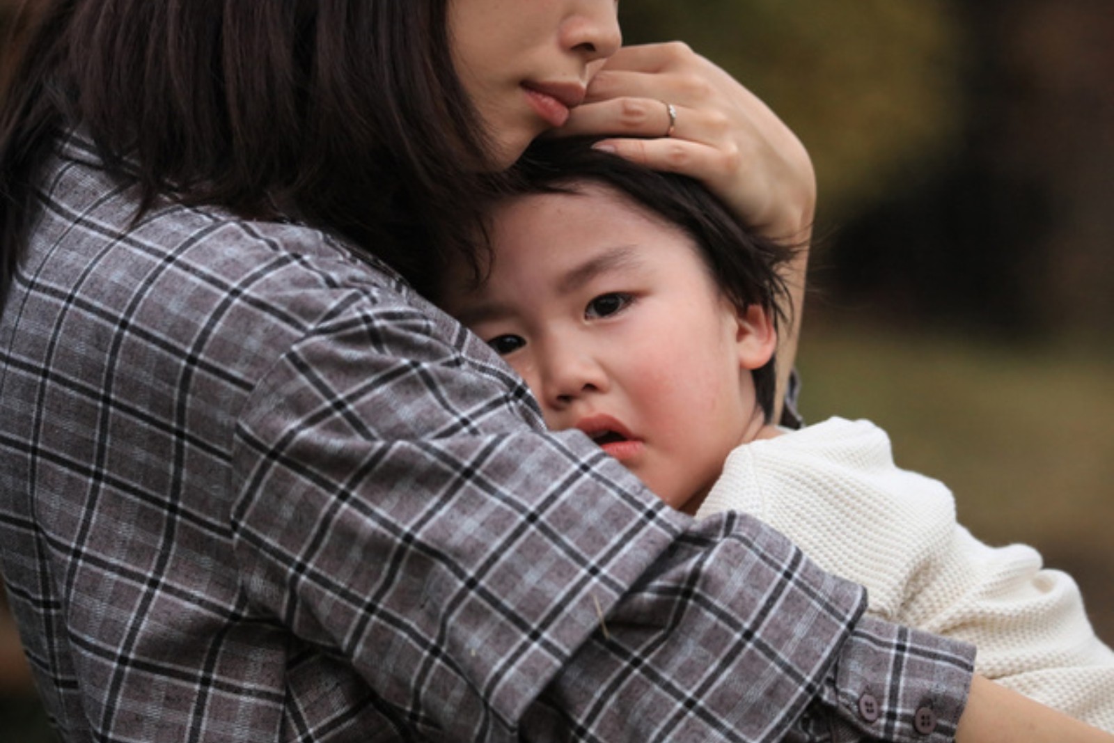 Parent comforting a child with eczema, considering probiotics for eczema relief