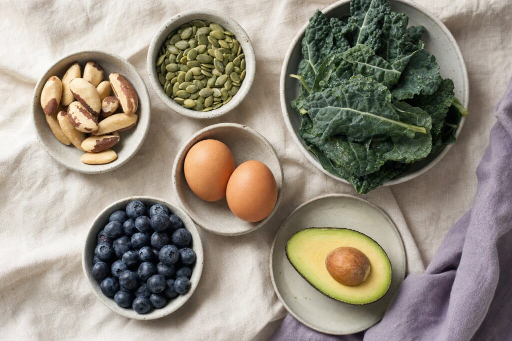 Wholefoods that support sperm health arranged in small dishes on linen