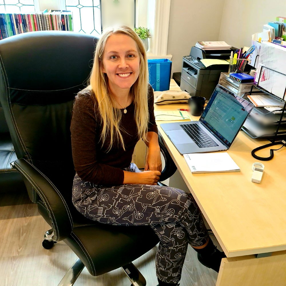 Madeline Sheppard, naturopath, seated at her desk at Living Holistic Health