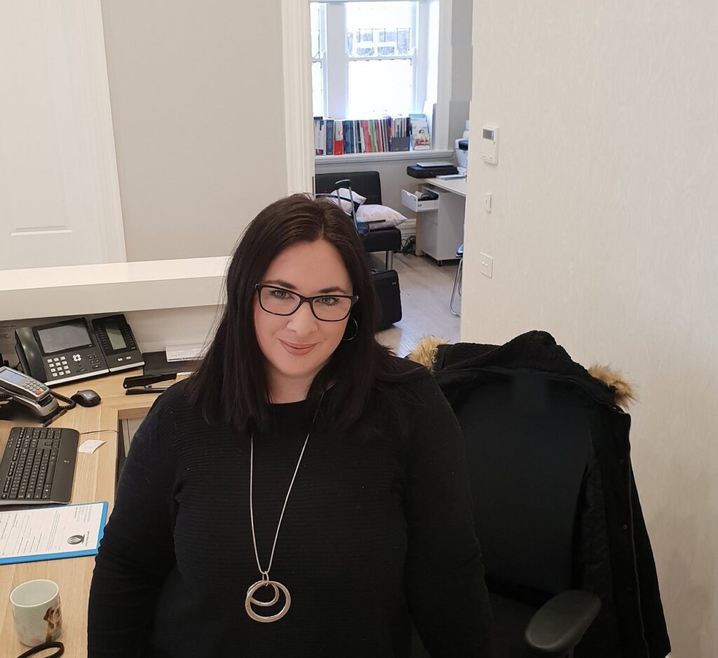 Morgan Helmling, naturopath, at the reception desk at Living Holistic Health